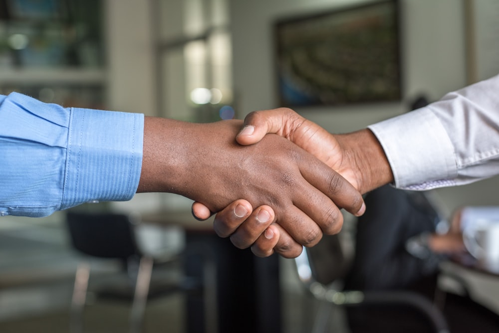 Two business professionals shaking hands to close a financing agreement